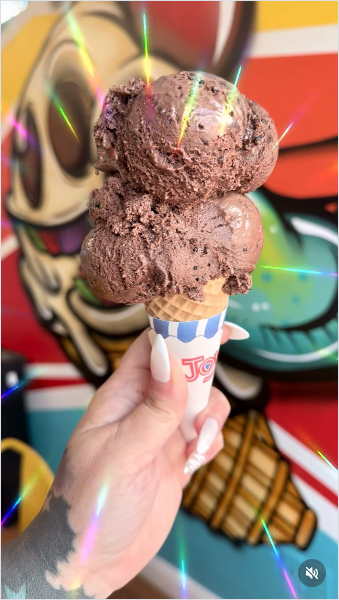 Chocolate lovers ice cream cone with vibrant mural wall background