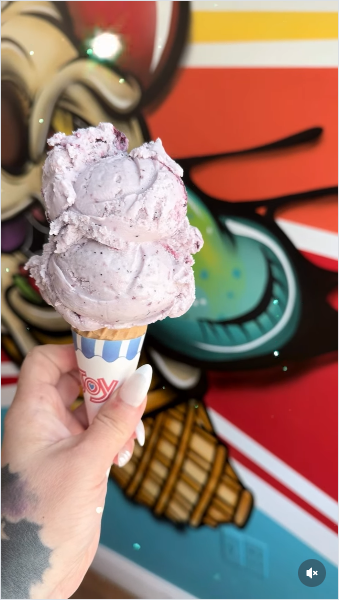 Maine blueberry ice cream cone with colorful mural backdrop